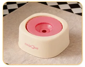Detail view of the anti-spill floating pet water bowl in beige and pink, clean design.