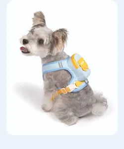 Detail close-up of blue plaid pet dog harness backpack, showing quality buckle and stitching.