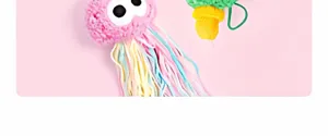Cute pink jellyfish cat toy with colorful tentacles and googly eyes, perfect for pet playing.