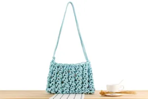 Light blue handmade woven knotted shoulder bag detail view, casual resort style everyday accessory.