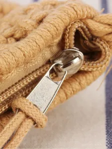 Minimalist cotton rope woven bag detail shot showcasing metal zipper and textured fabric