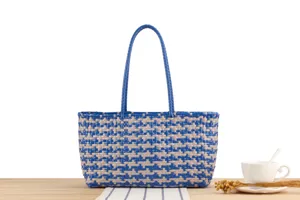 Blue and beige woven tote bag detail, stylish plastic beach shoulder bag for women.