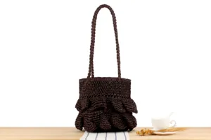 Close-up detail of the dark brown handmade woven shoulder bag with chic ruffled layers.