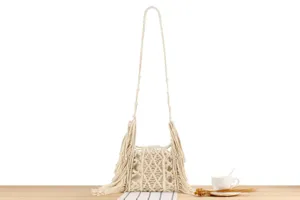Handmade macrame woven shoulder crossbody bag detailed view featuring intricate fringe and cotton.