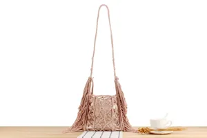 Handmade pink macrame woven shoulder bag detail, showcasing intricate fringe and texture.
