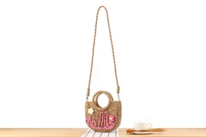 Handmade straw woven crossbody bag with cute hello letter decoration for summer beach vacation.