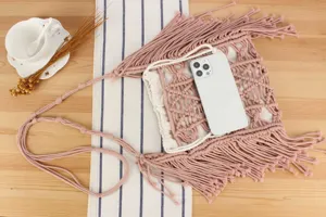 Handmade pink macrame crossbody bag with fringe, casual woven shoulder bag for beach vacation.