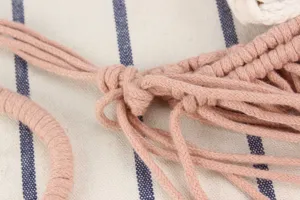 Handcrafted macrame pink woven bag detail showcasing delicate knotting and texture.