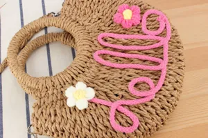 Handwoven straw circle handbag with floral decor and top handles for summer beach casual daily.