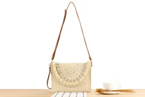 Bohemian straw woven crossbody shoulder bag featuring delicate seashell trim for resort style.