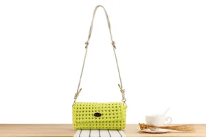 Close-up detail of the lime green woven crossbody bag showcasing its unique hollow design.