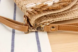 Woven straw bag strap and clasp detail, seashell fringe trim, boho vacation style accessory.