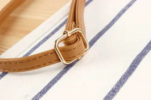 Detailed close-up of a stylish brown PU leather bag strap with a gold metal adjustable buckle.