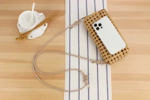 Detail shot of hollow woven shoulder bag on wooden table with elegant props for daily use.