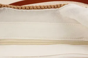Handcrafted woven shoulder bag interior zipper and premium lining detail close-up
