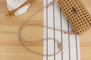 Detailed view of hollow woven shoulder bag strap and texture, casual everyday style for women.