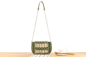 Green handwoven crochet crossbody bag with gold chain strap, chic summer beach purse.