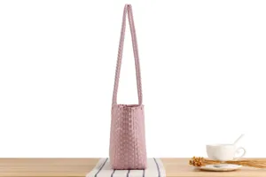 Chic pink plastic woven tote bag for women, casual daily market basket and stylish beach purse.