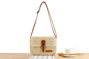 Detailed shot of a woven crossbody bag with brown leather straps, perfect for casual daily use.