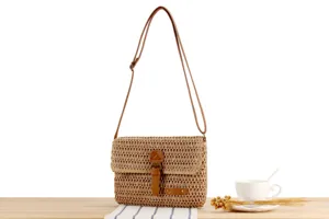 Woven crossbody bag with brown leather straps and flap closure, retro style detail view for casual wear.
