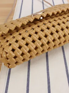 Stylish hollow woven crossbody bag for women, chic beach vacation shoulder handbag.
