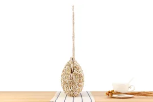 Detailed view of handmade woven straw bag, dual color pattern, elegant casual beach style.