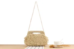 Handmade woven straw bag detail shot showcasing texture and chain strap features.