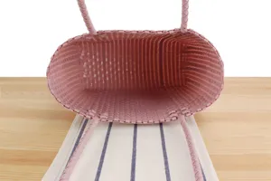 Pink plastic woven tote bag, casual beach vacation picnic basket, minimalist style everyday use.