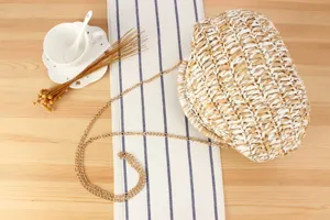 Stylish two-tone woven straw handbag with gold chain strap, perfect for daily casual and beach vacation.