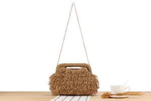Handmade woven straw shoulder bag detail view, casual chic design with metal chain strap.