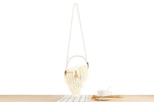 Handmade woven crossbody handbag with pearl strap, unique shell design for casual beach vacation.