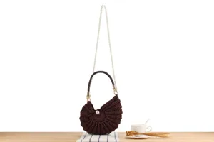 Handmade brown crochet shell shoulder bag with pearl chain detail for women beach travel.
