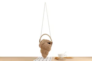 Handcrafted woven shell crossbody bag with pearl strap, unique casual holiday handbag detail view.