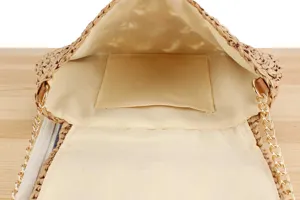 Detailed view of the handmade woven straw handbag interior with lining and chain strap for women.
