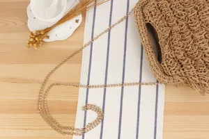 Handmade straw woven shoulder bag with gold chain, ideal for casual daily use and beach holidays.