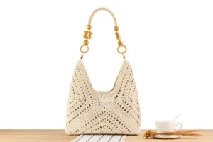 Close-up of beige crochet shoulder bag featuring unique wooden bead handle, casual summer style.