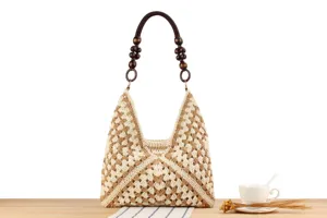 Crochet shoulder bag detail, beige knit pattern with wooden bead handle, elegant casual daily style.