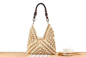 Detailed close-up of a stylish beige and khaki crochet shoulder bag with wooden bead handles.