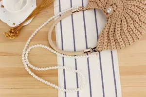 Handmade woven crochet women handbag with elegant pearl strap and leather braided strap for daily use.