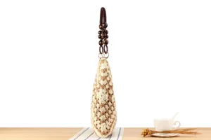 Detail view of woven cotton rope shoulder bag with wood beads for casual beach summer style.