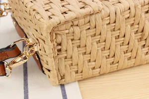 Handmade woven straw bag texture detail close-up, showcasing stylish structured handbag hardware.