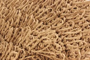 Close-up detail of handmade woven straw bag texture, natural raffia material, chic style.