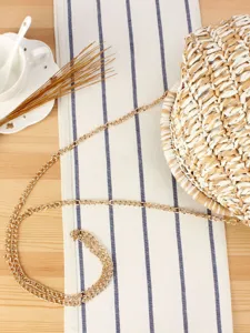 Chic round straw woven crossbody bag with gold chain strap for casual summer beach daily.