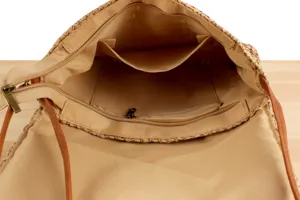 Detailed interior view of woven straw bag with zip pocket and fabric lining structure.