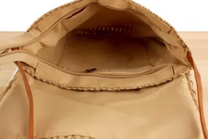 Straw woven bag interior detail showing durable fabric lining zipper pocket design.