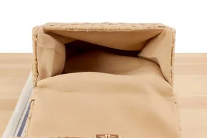 Close-up detail view of the handmade straw woven bag interior lining and texture.