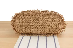 Handmade woven straw bag bottom detail, casual seaside holiday tote bag texture display.