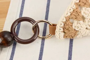 Detailed view of handmade crochet woven shoulder bag with stylish metal hardware and wooden bead.