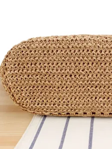 Straw woven bag bottom detail view showing close-up texture and natural craft design.