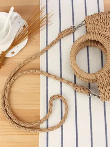 Handcrafted straw woven crossbody bag, stylish round handle casual beach handbag for women.